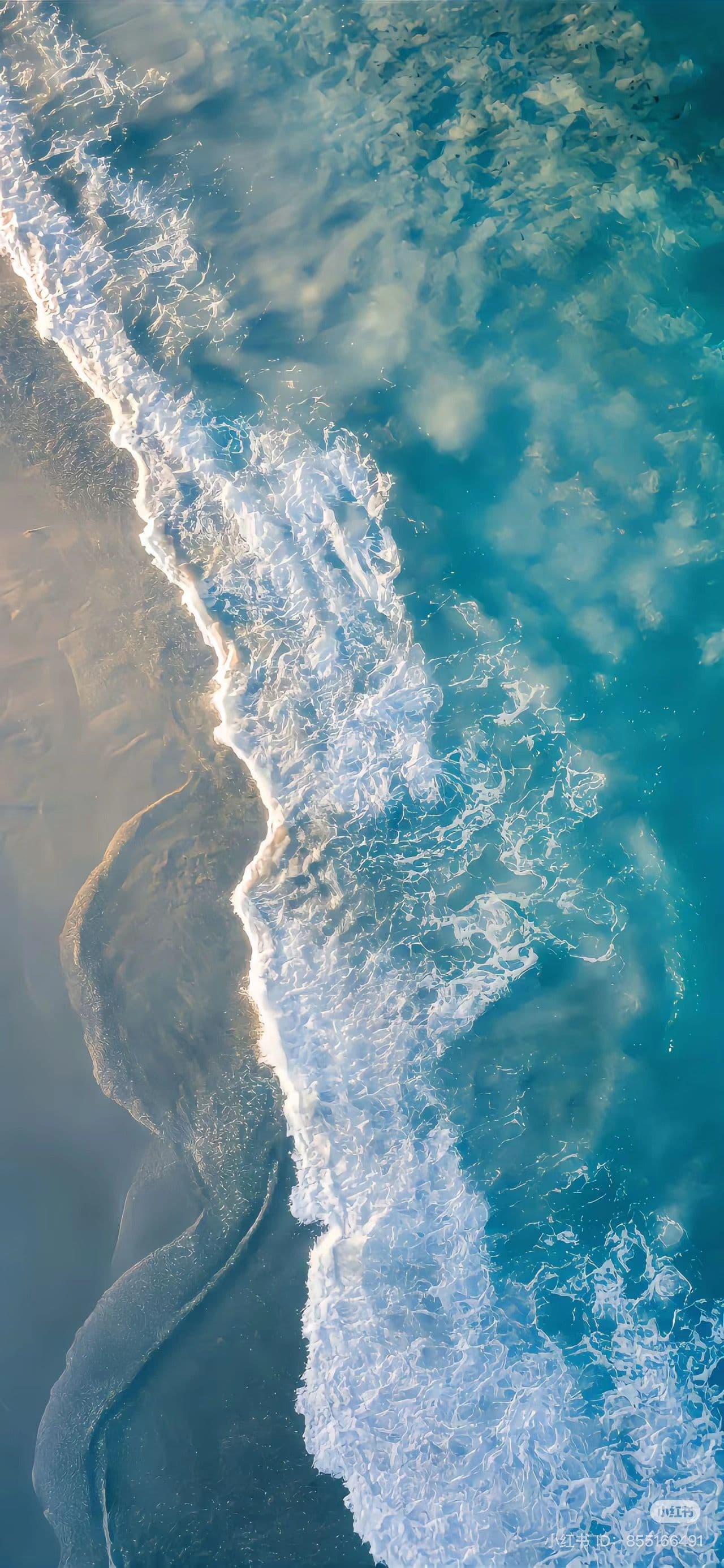 Turquoise Ocean Waves Meeting Sandy Beach Shore