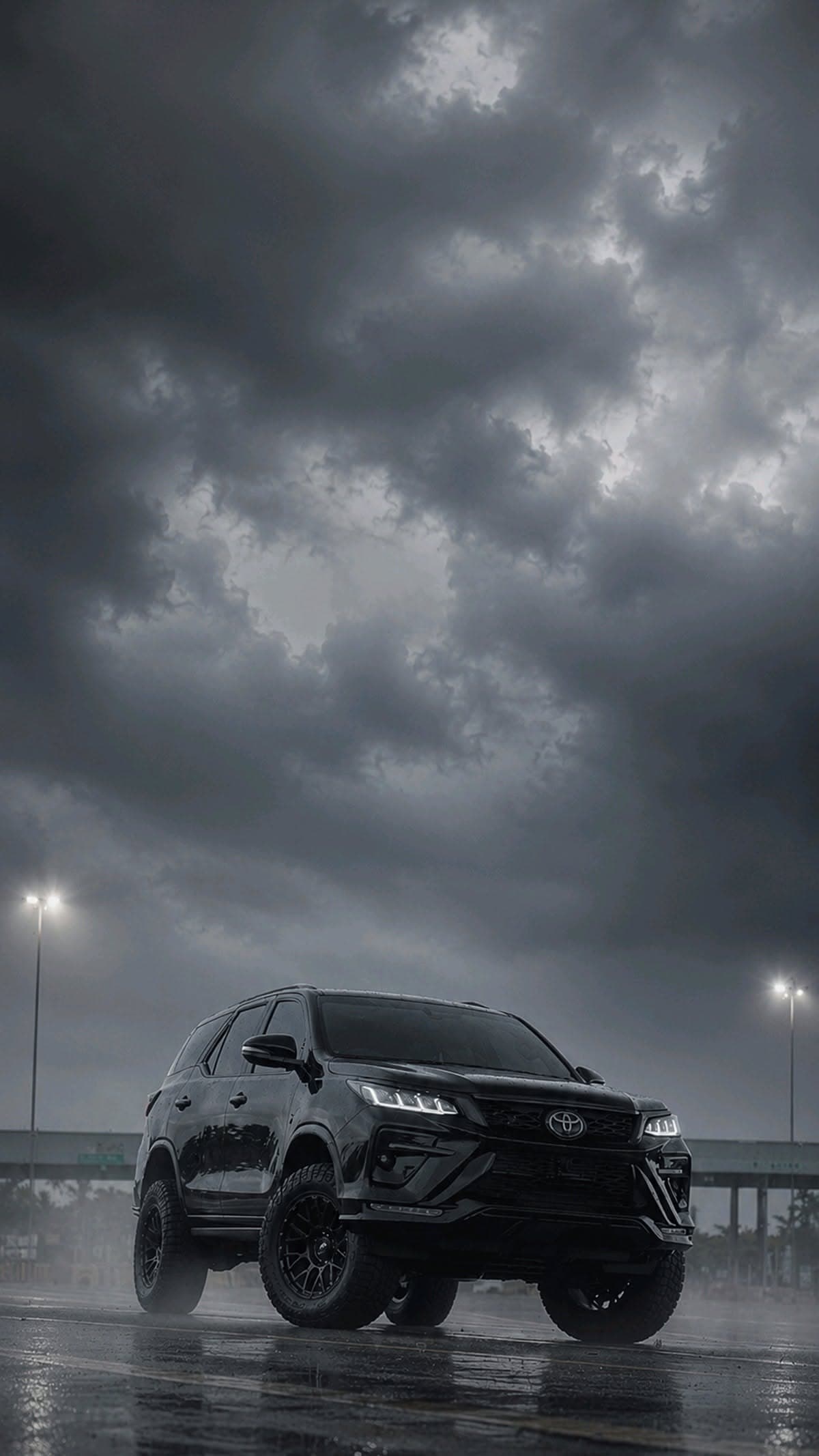 Black Toyota Fortuner Under Stormy Sky