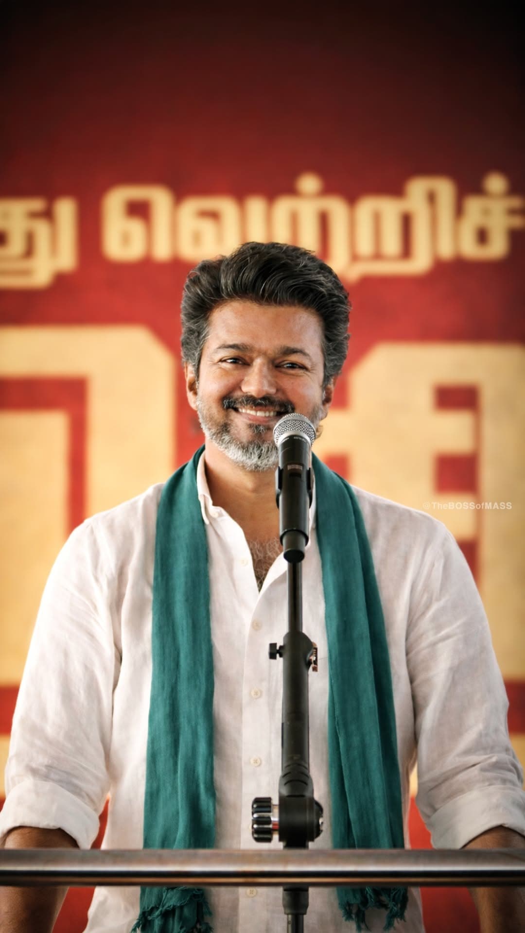 Actor Vijay Smiling at Microphone