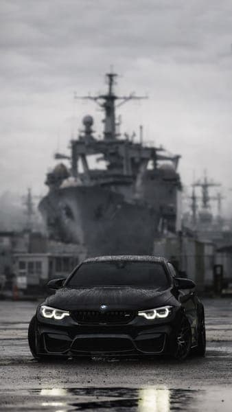Black BMW M4 Sports Car Military Harbor Background
