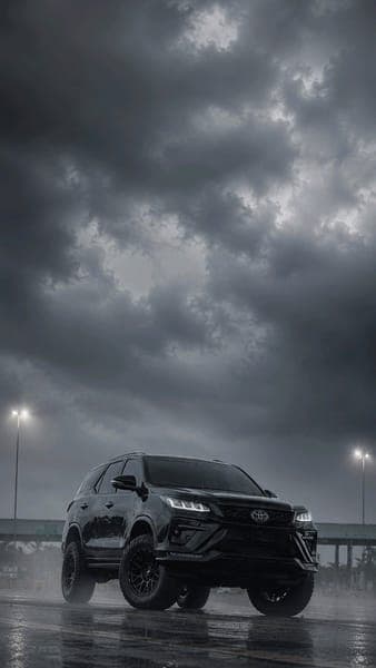 Black Toyota Fortuner Under Stormy Sky