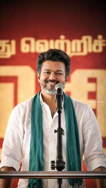 Actor Vijay Smiling at Microphone